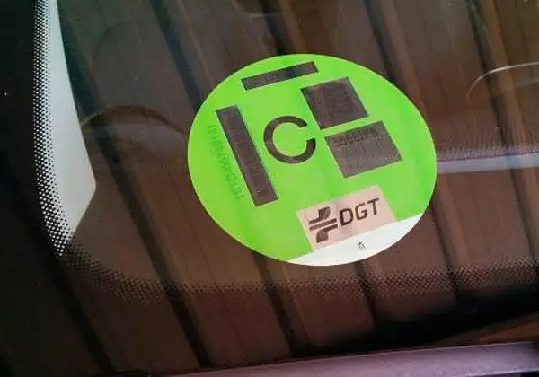 Etiqueta DGT de distintivo ambiental C en parabrisas.